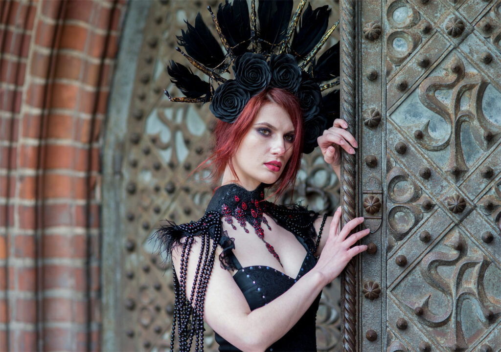 A woman with red hair is wearing AW Bridal little black dress.