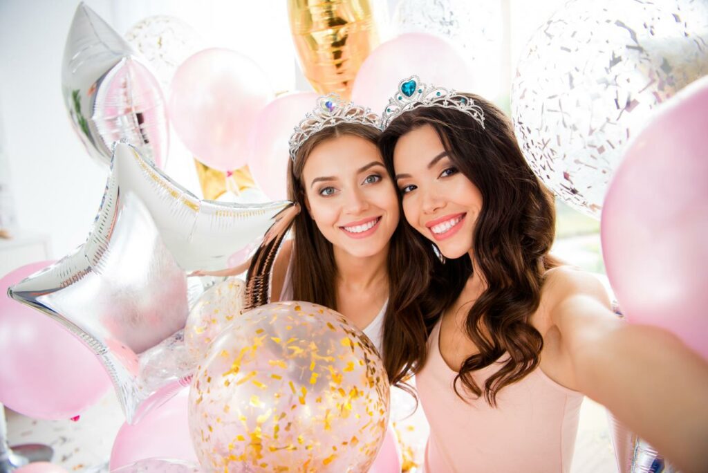 A beautiful bride was taking a selfie with her friend, both smiling happily.